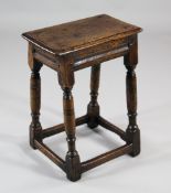 A 17th / 18th century oak joynt stool, with ring turned legs united by stretchers, W.1ft 4in.
