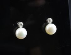 A pair of 18ct white gold, cultured pearl and diamond set earrings.