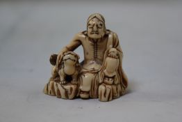 A Japanese ivory netsuke of Shubaka Sonja, 18th / 19th century, typically seated and stroking a