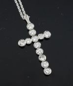 A white gold and diamond cross pendant, set with twelve diamonds and diamond set bale, on a platinum