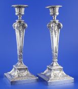 A pair of George V silver candlesticks by Elkington & Co, the matt finish square tapering stems