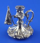 A Victorian silver chamberstick and snuffer, once belonging to a desk stand, with foliate borders