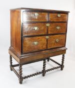 A burr walnut cross banded chest, of two short and two long drawers on a stand with barley twist