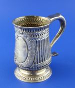 A George III provincial silver baluster mug, with later? fluted decoration and ornate cartouche with