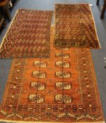 Three 1920`s Bokhara rugs, each with field of polygons on a red ground, 4ft 10in by 3ft 4in et