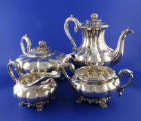 A 1970`s Victorian style silver four piece tea and coffee service, of melon form, with foliate