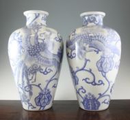A pair of large Japanese blue and white vases, Meiji period, each painted with phoenixes amid
