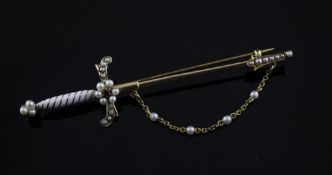 A Victorian gold, white enamel, seed pearl and ruby set bar brooch, modelled as a sword, with seed