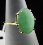 An 18ct gold and cabochon jadeite ring, of oval form, size I.