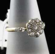 An 18ct gold and diamond cluster ring, of flower head design, with diamond set shoulders, size P.