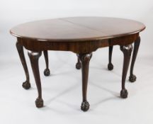 A Victorian oval walnut extending dining table, with two extra leaves, on shell carved legs with