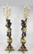 A pair of 19th century style Blackamoor figures, each holding a cornucopia, issuing five sconces,