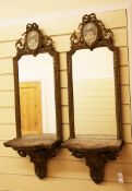 A pair of 19th century carved giltwood and gesso mirrored wall brackets, the acanthus scroll
