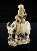 A Chinese ivory group of a figure seated on an ox, Qing dynasty, on a rock work base with lingzhi