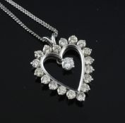A white gold and diamond heart shaped drop pendant, set with nineteen stones weighing
