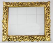 A 19th century carved giltwood rectangular Florentine wall mirror, with rectangular mirror plate