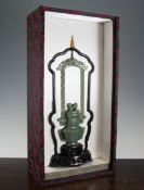 A Chinese archaistic green jade hanging vase, mid 20th century, the flattened baluster shape vase