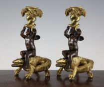 A pair of 20th century French bronze and ormolu mounted figural candlesticks, modelled as winged