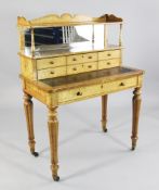A Victorian maple bonheur du jour, the raised superstructure with mirror back over six small drawers