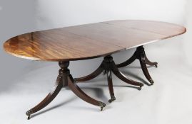 A Regency style mahogany D end extending dining table, with two extra leaves, on triple pillar