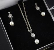 A white gold, diamond and cultured pearl suite of jewellery, comprising pair of drop earrings and