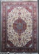 A Tabriz carpet, with polychrome field of scrolling foliage and central medallion, on an ivory and