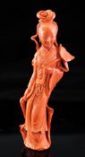 A large Chinese coral figure of He Xiangu, mid 20h century, carved in relief and open work with a