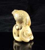 A Japanese ivory carving of an eagle and an octopus, early 20th century, the eagle grasping the