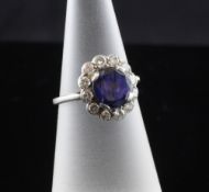 A 1940`s/1950`s platinum, sapphire and diamond cluster ring, of oval form, size J.
