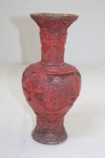 A Chinese cinnabar lacquer yen yen vase, 19th century, carved in high relief with sages and