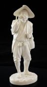 A Japanese ivory figure of a farmer, Meiji period, in standing pose, holding a cane and playing a