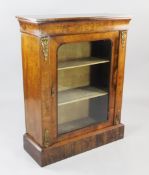 A Victorian marquetry inlaid walnut pier cabinet, with ormolu mounts and single glazed door, on