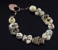 An early 20th century Japanese carved ivory bead bracelet, each link carved and decorated as a mask,