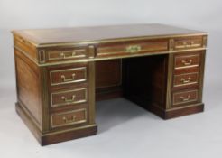 A late 19th century French mahogany and brass mounted pedestal desk, the top with gilt tooled