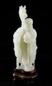 A Chinese white jade figure of Shou Lao, mid 20th century, holding a peach in his left hand and a