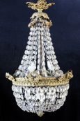 A French cut glass and brass chandelier, with laurel leaf and traditional classical mounts and