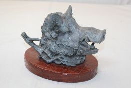 A late 19th century spelter boar`s head inkwell, on an oval brown crocodile skin plinth base, 5.