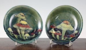 A pair of Moorcroft Claremont pattern dishes, c.1928, with green grounds, inscribed WM, impressed