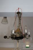 An Empire style six branch chandelier, with circular base and pineapple finial, with anthemion