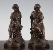 A pair of bronzed metal figures of seated musical maidens, Mignon and Carmen, 7in.