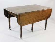 A Regency mahogany extending dining table, with ebony line inlay and drop ends with two extra