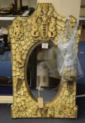 A 19th century Dieppe ivory framed wall mirror, with central oval bevelled plate glass, the frame