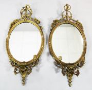 A pair of Victorian oval giltwood and gesso girandoles, with floral ribbon scrolling crests and twin
