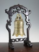 A Chinese bronze bell and rosewood stand, Xuande mark, early 20th century, the bell surmounted by