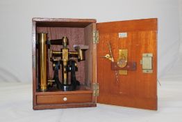 A late Victorian / early 20th century lacquered brass microscope, in original fitted mahogany case