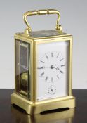 An early 20th century French gilt brass carriage alarum clock, with enamelled Roman dial, movement