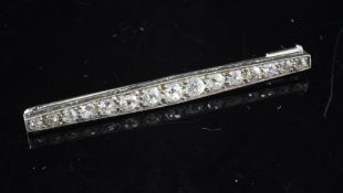 A 1920`s/1930`s 18ct white gold and platinum, diamond bar brooch, set with fifteen graduated old cut