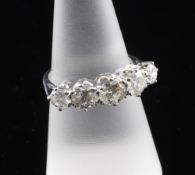An 18ct white gold and graduated five stone diamond half hoop ring, the total diamond weight