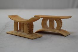 Two miniature carved ivory Ashanti stools, 4in.