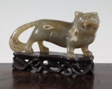 A Chinese agate carving of a lion-dog, 19th century, in standing pose, the grey brown stone with